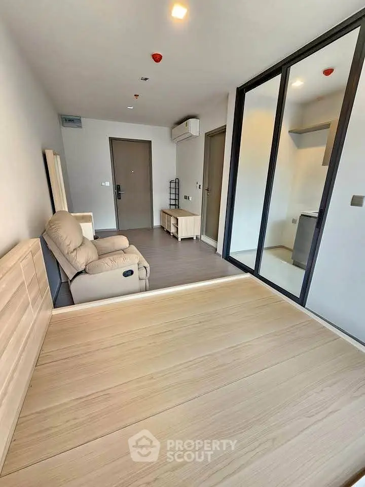 Modern living room with sleek design and glass partition in a stylish apartment.
