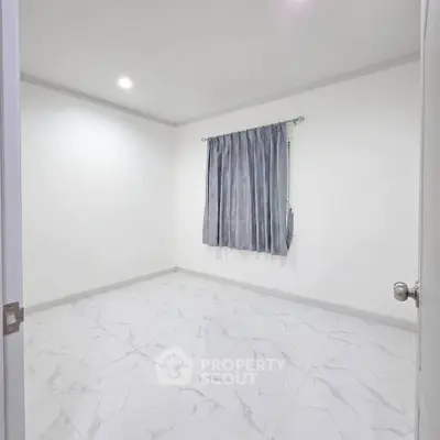 Spacious empty bedroom with marble flooring and elegant curtains, perfect for customization.