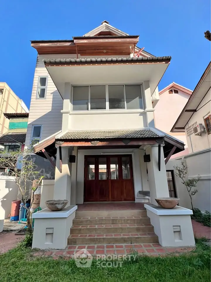 Charming two-story house with traditional architecture and inviting entrance, perfect for family living.