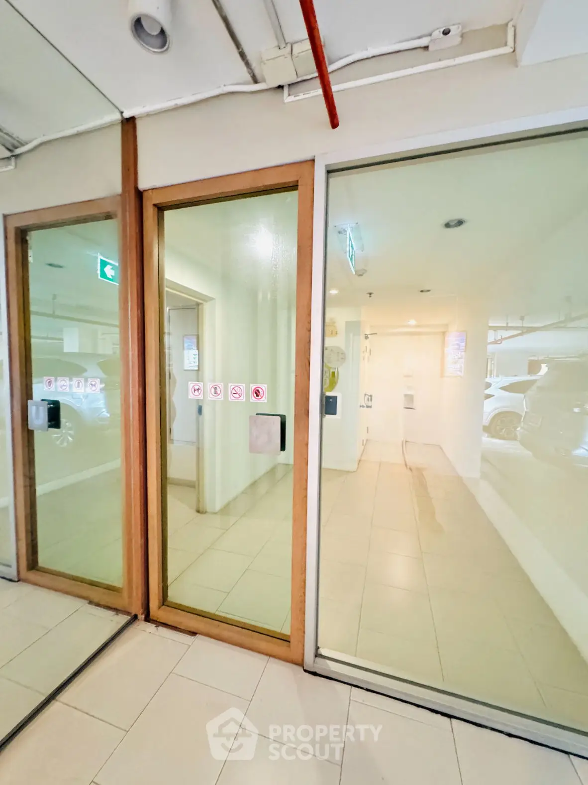 Modern building entrance with glass doors and tiled flooring
