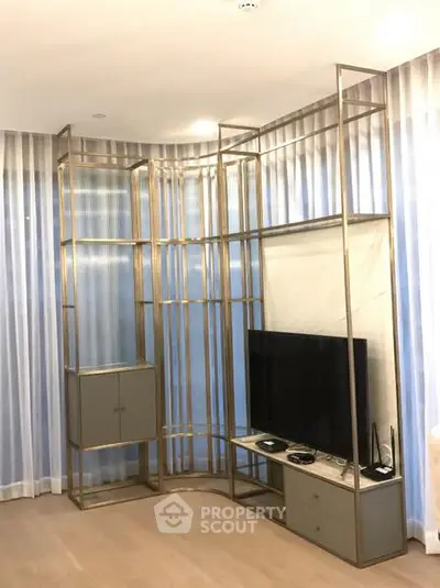 Modern living room with sleek metal shelving and flat-screen TV, perfect for stylish urban living.