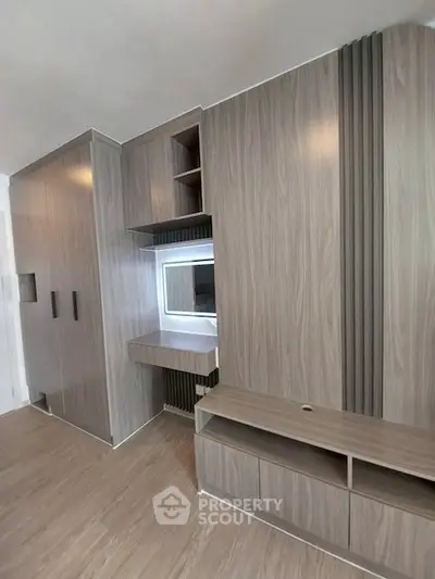 Modern built-in storage unit with sleek wood finish in a contemporary apartment interior.
