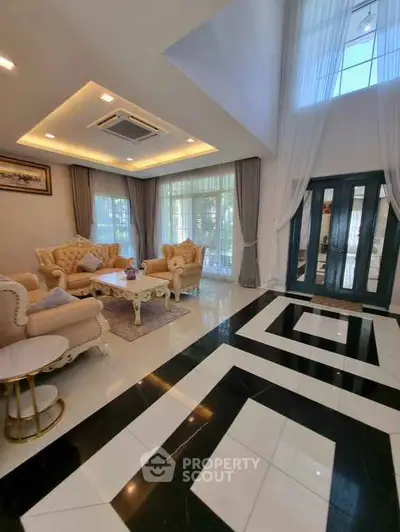 Luxurious living room with elegant furniture and high ceiling design