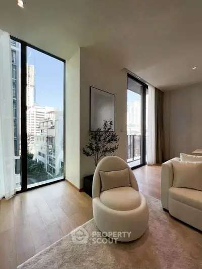 Luxurious modern living room with floor-to-ceiling windows and city view, featuring elegant furniture and natural light.
