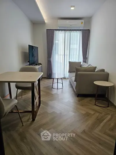 Modern living room with stylish furniture and natural light, perfect for relaxation and entertainment.
