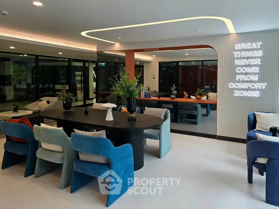 Modern living room with stylish furniture and motivational neon sign