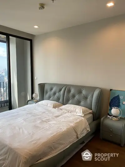 Luxurious bedroom with modern decor and city view balcony in high-rise apartment