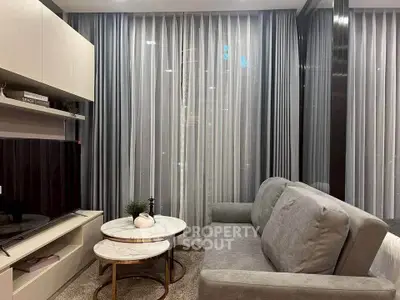 Modern living room with sleek furniture and elegant curtains in a stylish apartment.