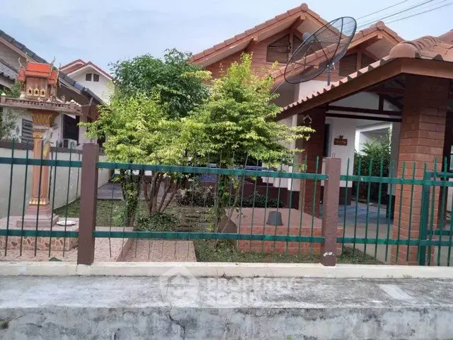 Charming suburban house with tiled roof and lush garden, perfect for family living.