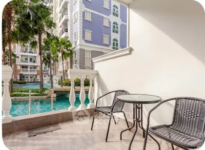 Charming balcony with pool view in modern apartment complex