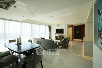 Luxurious living room with elegant dining area and large windows offering natural light