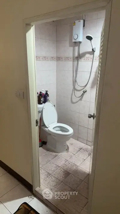 Compact bathroom with shower and toilet in cozy real estate unit