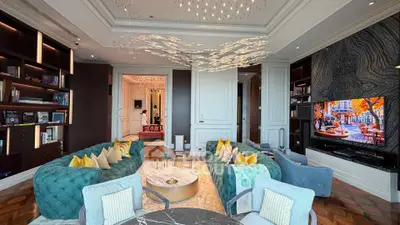 Luxurious living room with elegant decor, plush seating, and modern entertainment setup.