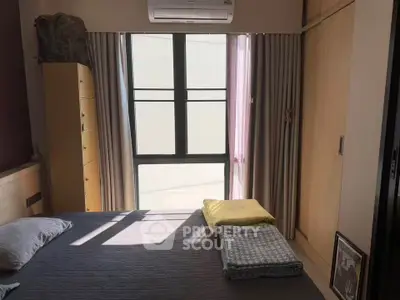 Cozy bedroom with natural light, modern furnishings, and ample storage space.