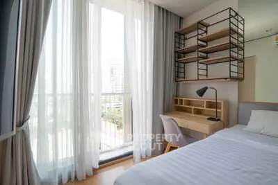 Modern bedroom with large window and stylish shelving in urban apartment