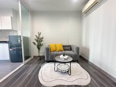 Modern living room with stylish gray sofa, air conditioning, and cozy decor in a contemporary apartment.