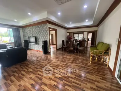 Spacious living room with modern decor and wooden flooring