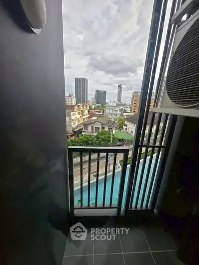 Urban balcony with city view and pool, perfect for modern living.