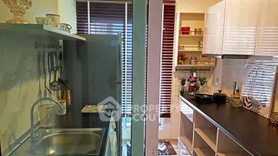 Compact kitchen with modern appliances and open shelving, perfect for efficient cooking in a cozy space.