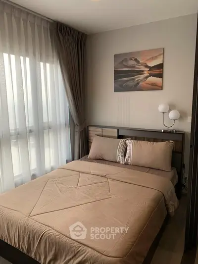 Cozy bedroom with elegant decor and large window for natural light