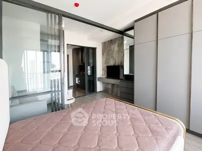 Modern bedroom with sleek design and built-in storage in a contemporary apartment.