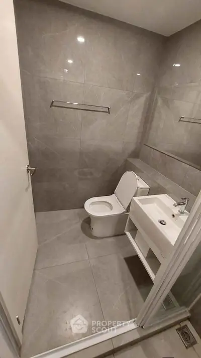 Modern bathroom with sleek gray tiles and contemporary fixtures