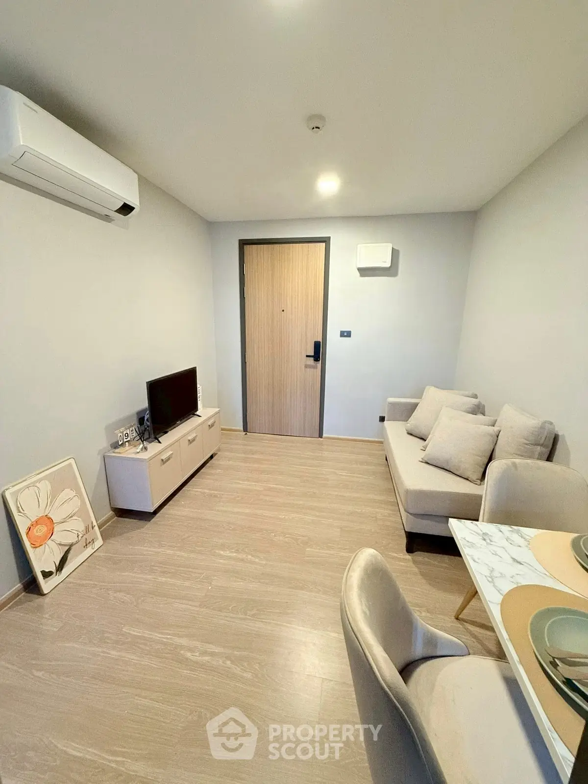 Modern living room with sleek furniture and air conditioning, perfect for cozy living.