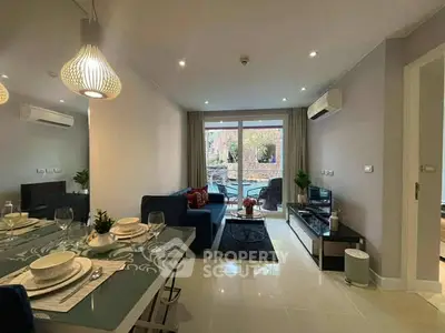 Modern living room with elegant dining area and large windows for natural light.