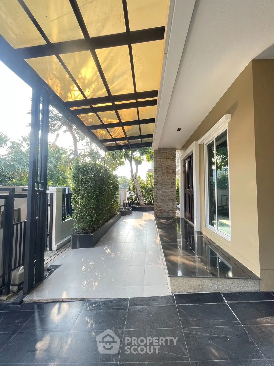 Modern home entrance with sleek design and lush greenery