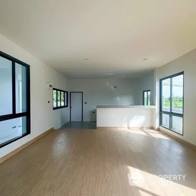 Spacious modern living room with large windows and natural light