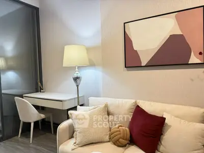 Modern living room with stylish decor, featuring a cozy sofa, elegant lamp, and abstract wall art.
