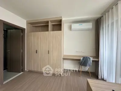 Modern bedroom with built-in wardrobe and air conditioning unit