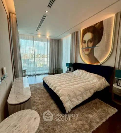 Luxurious bedroom with modern art, plush carpet, and large windows offering city views.