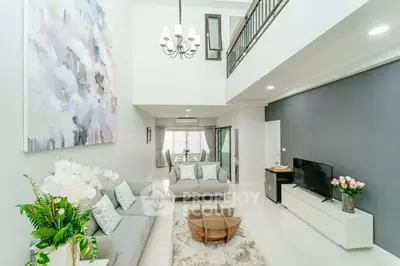 Spacious modern living room with high ceiling and elegant decor