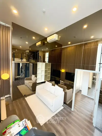 Modern living room with mirrored walls and stylish furniture in a luxurious apartment.