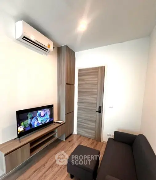 Modern living room with sleek furniture and air conditioning, perfect for cozy relaxation.