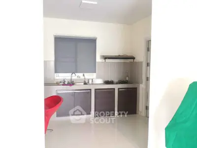 Modern kitchen with sleek cabinets and gas stove in a bright, minimalist design.