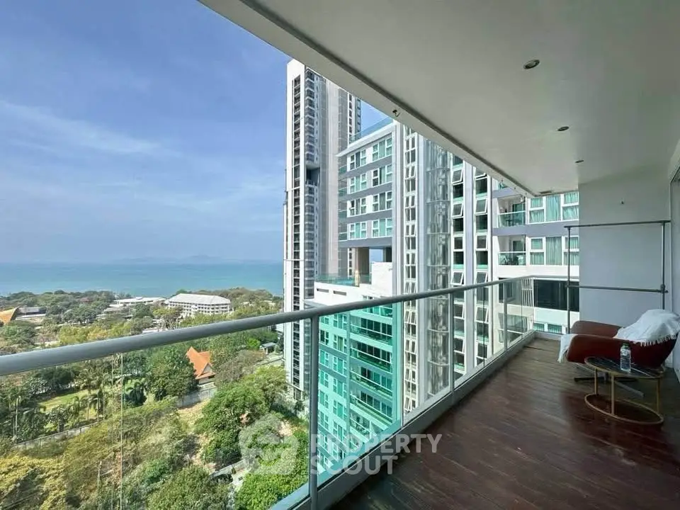 Stunning high-rise balcony with ocean view and modern cityscape, perfect for urban living.