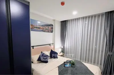 Modern bedroom with cozy decor and large window with curtains