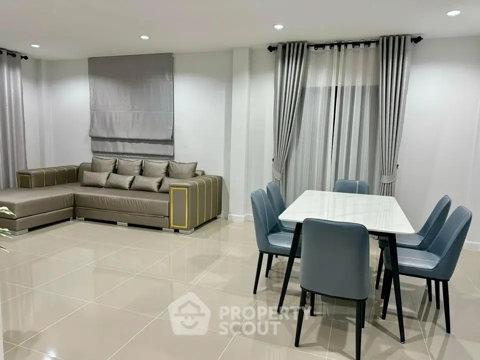 Modern living room with stylish furniture and dining area