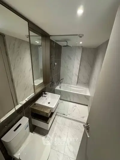 Modern bathroom with sleek design, featuring a bathtub and elegant fixtures.