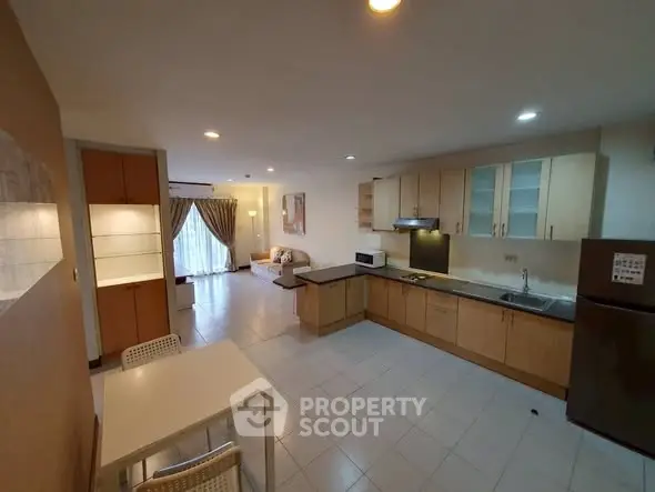 Spacious open-layout kitchen and living area with modern appliances and natural light.