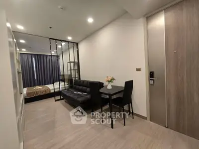 Modern studio apartment with sleek interior design and cozy living area.