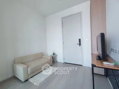 Modern minimalist living room with beige sofa and TV setup