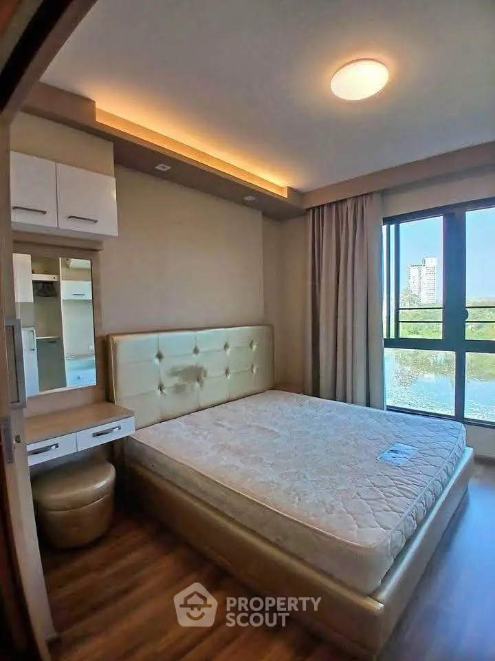 Luxurious bedroom with modern decor and large window view