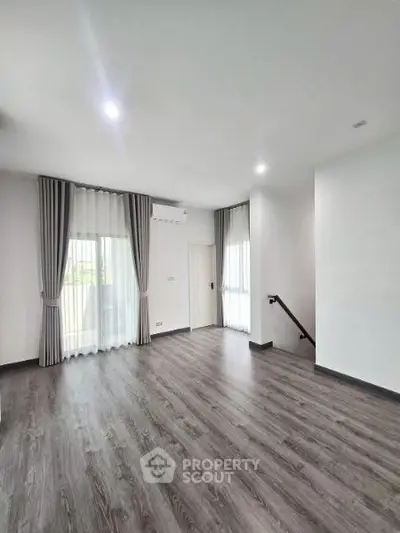 Spacious modern living room with elegant flooring and natural light