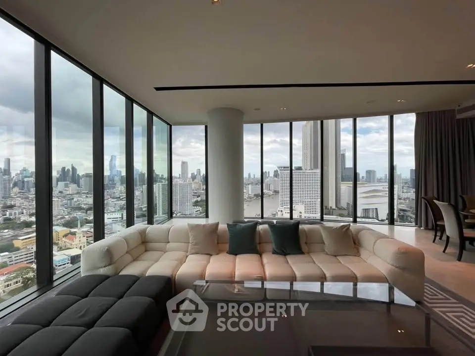 Luxurious corner unit living room with panoramic city views and elegant furnishings.