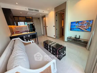Modern living room with open kitchen, stylish decor, and wall-mounted TV in a contemporary apartment.
