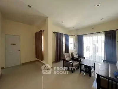 Spacious living room with natural light and modern furniture