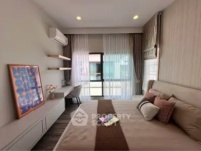 Modern bedroom with stylish decor and large window offering natural light